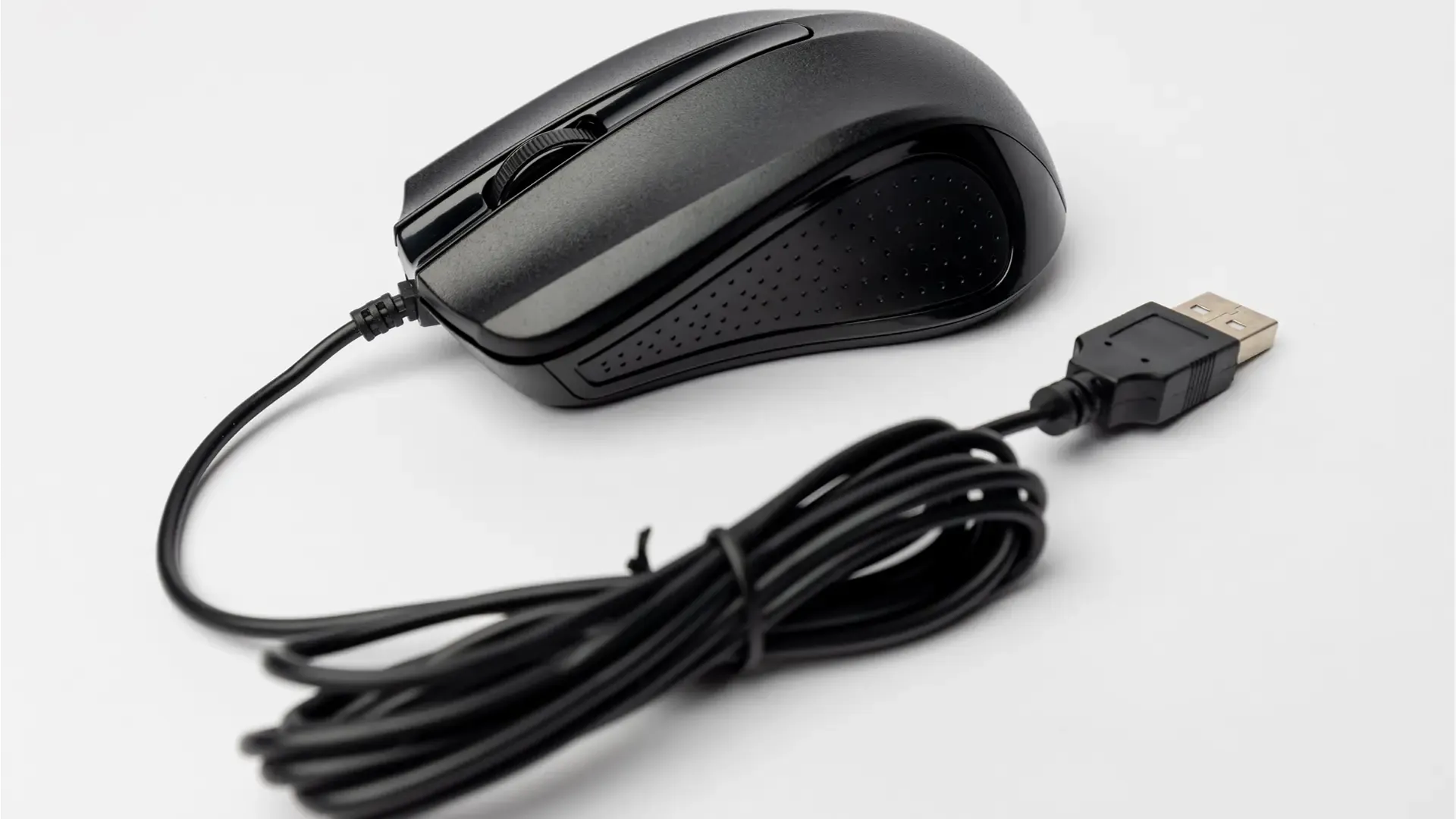 A black wired mouse on a light background